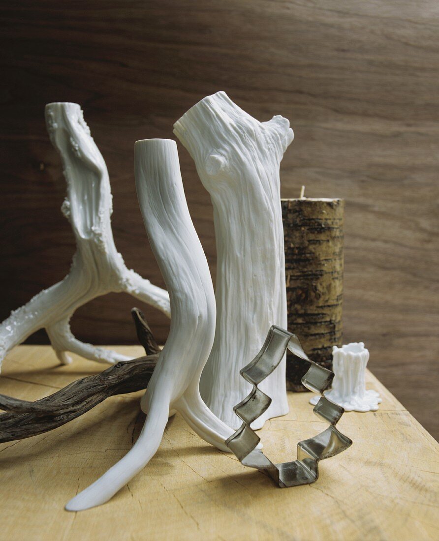 Stylised white branches and festive cookie cutters on table