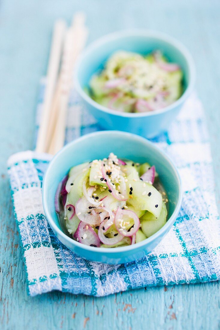 Cucumber salad with red onions and sesame seeds (Asia)