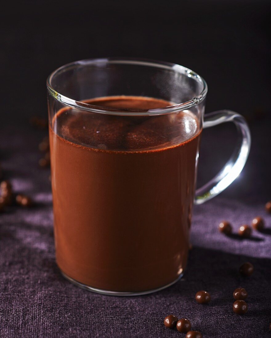 A glass mug of hot chocolate