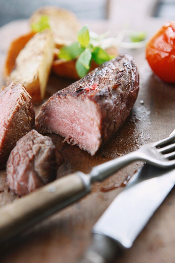 Beef steak and vegetables on a chopping board