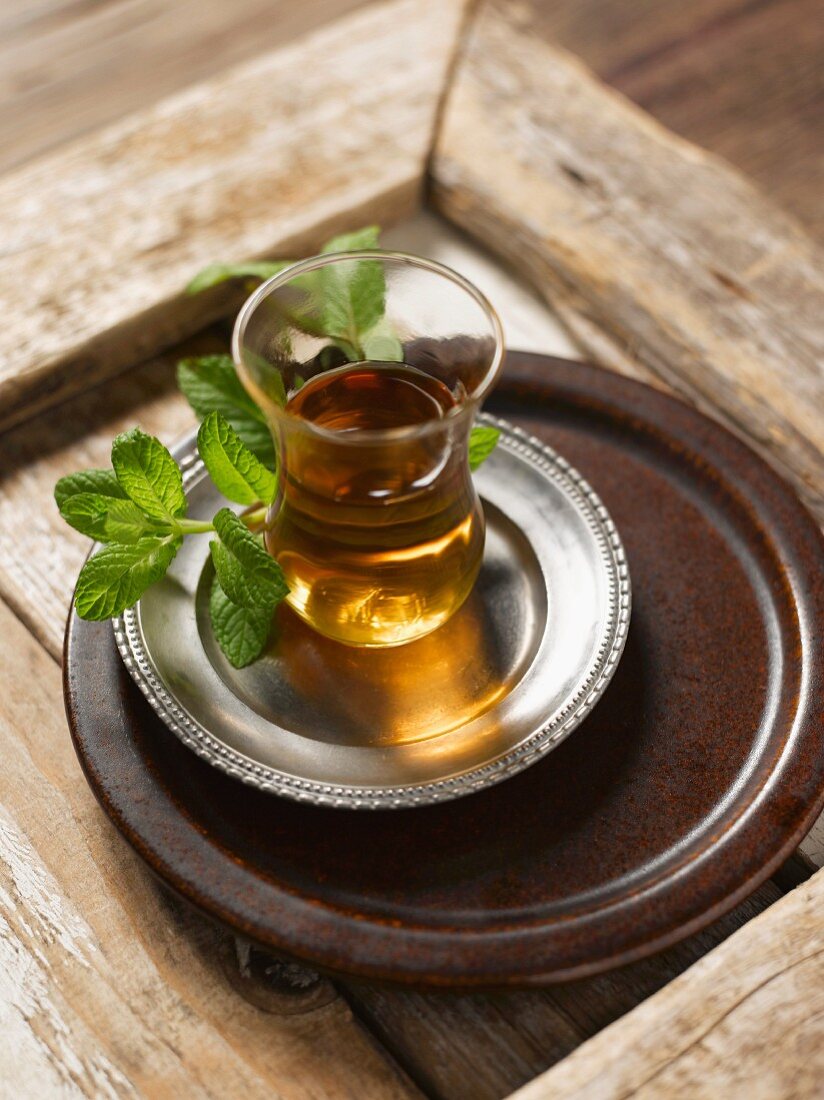 Black tea with fresh mint on a tray