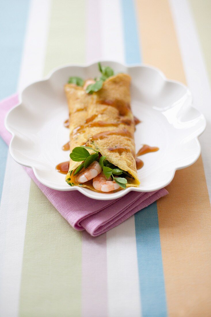 A pancake with prawns and pea shoots