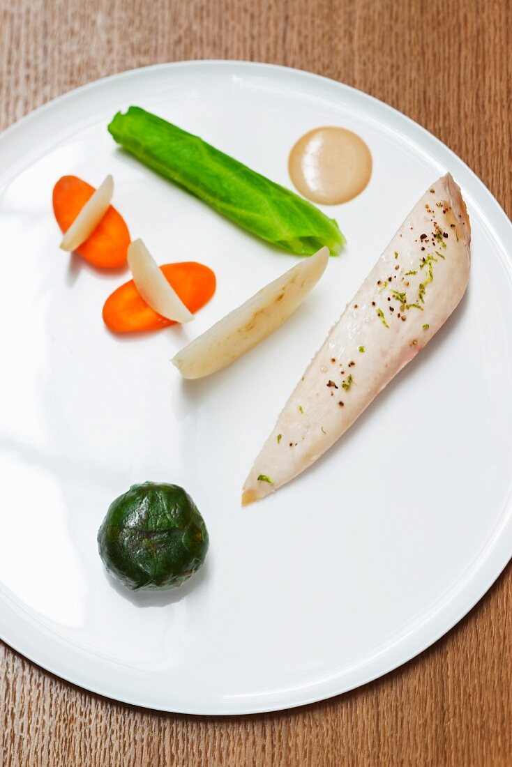 Poached chicken breast with vegetables