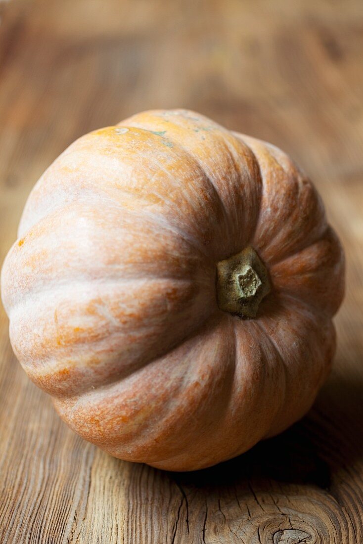 Musquee de Provence squash on a wooden surface