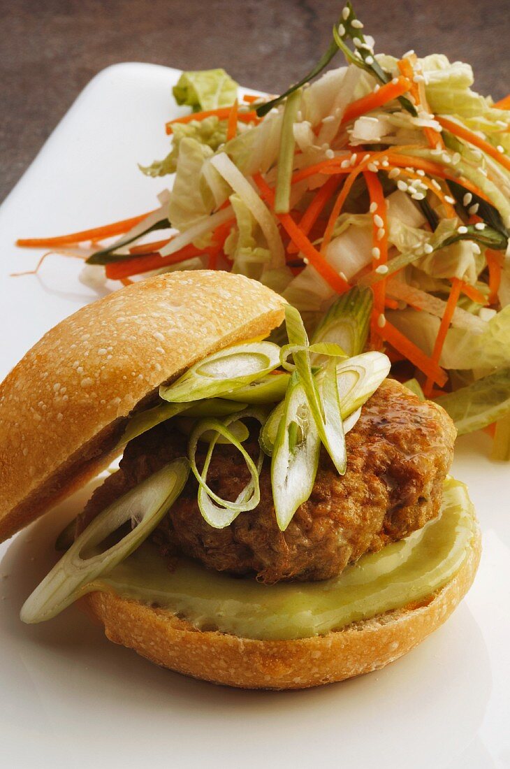 Burger with spring onions and Chinese cabbage salad (Korea)