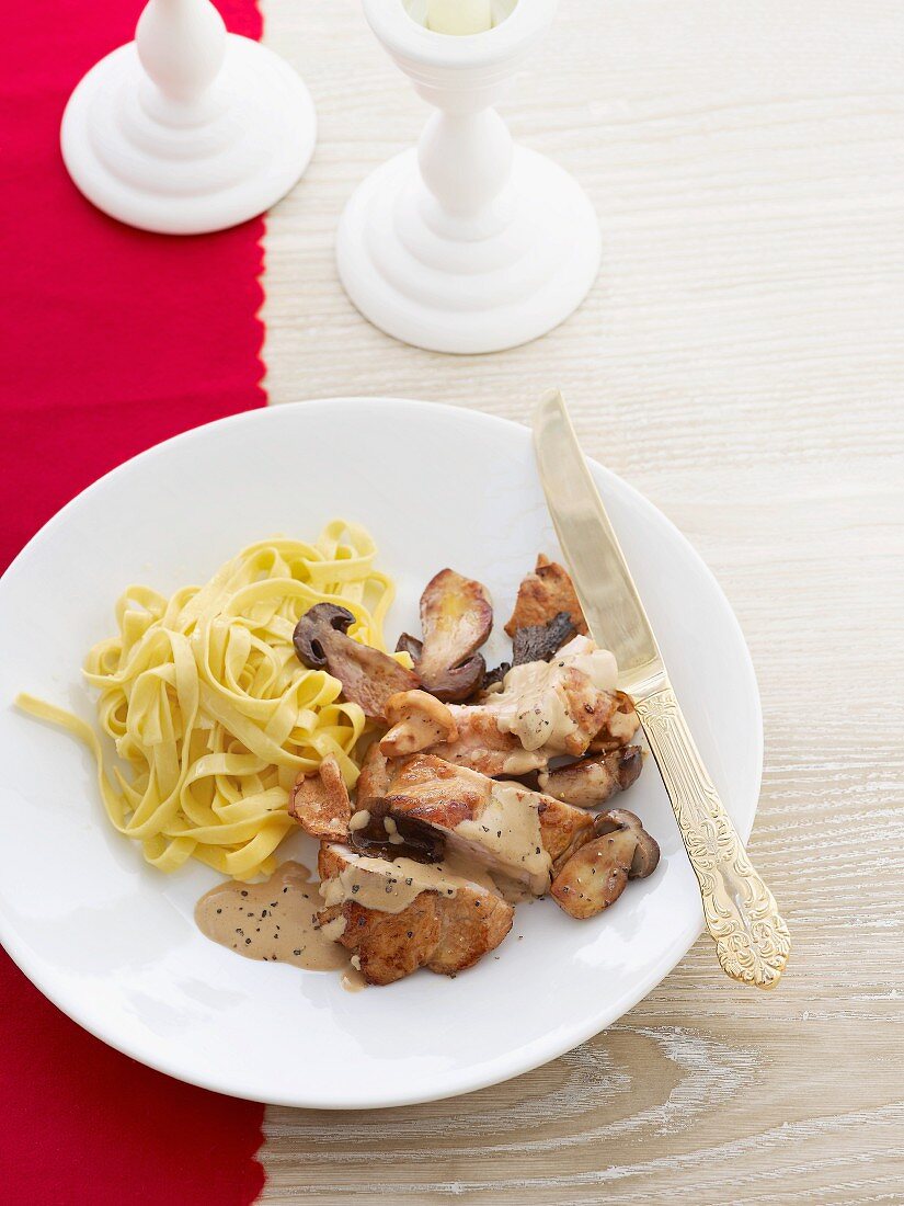 Veal schnitzel with mushroom sauce and ribbon pasta