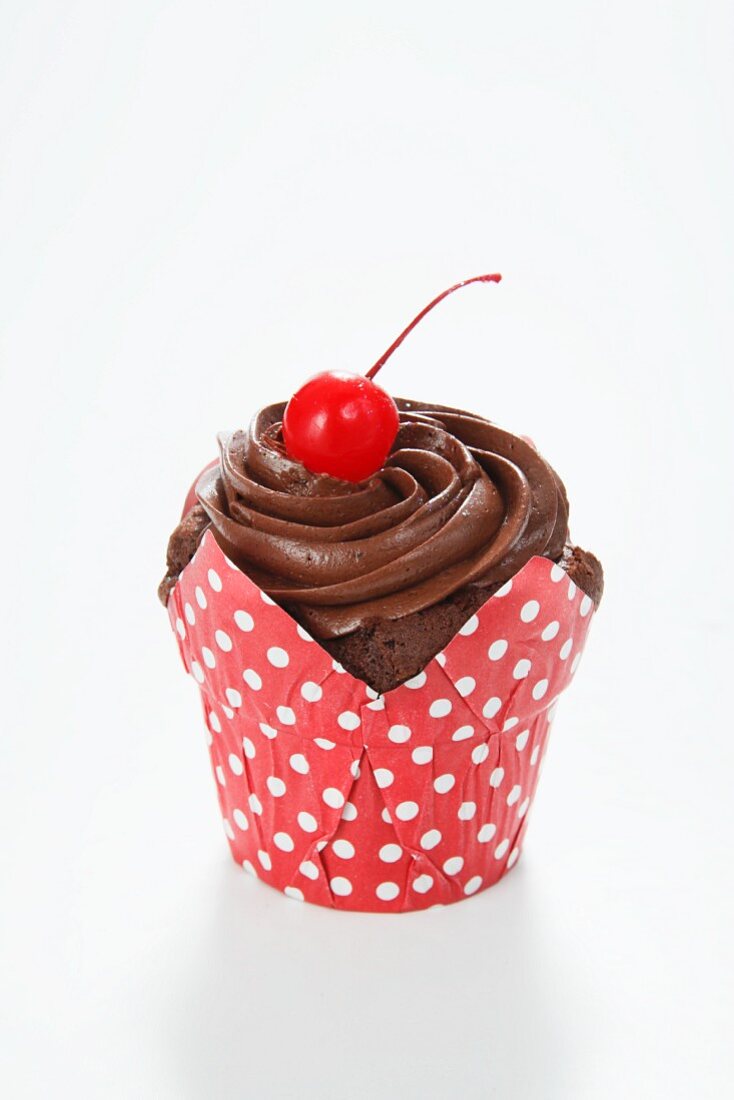 Chocolate cupcake topped with a cherry