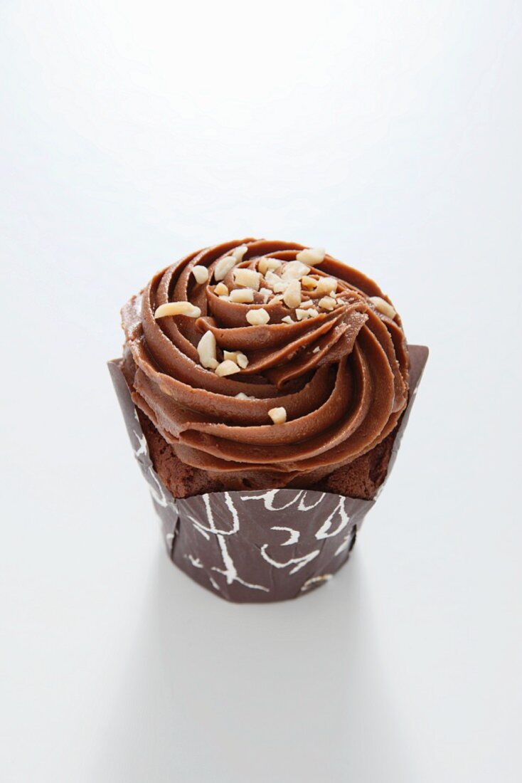 Chocolate cupcake topped with nuts