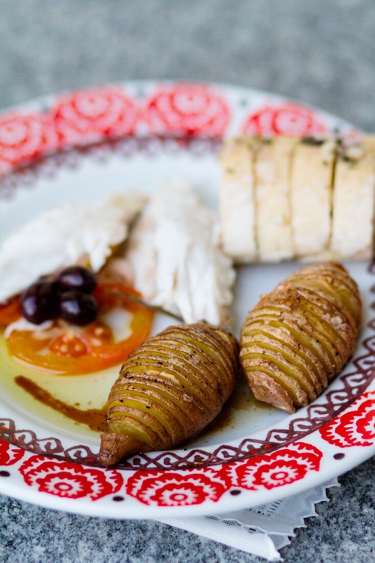 A plate of starters with Hasselback potatoes