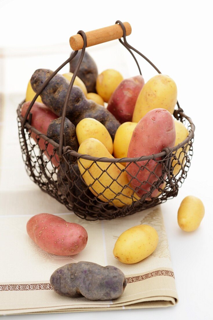 Assorted varieties of potato in a wire basket