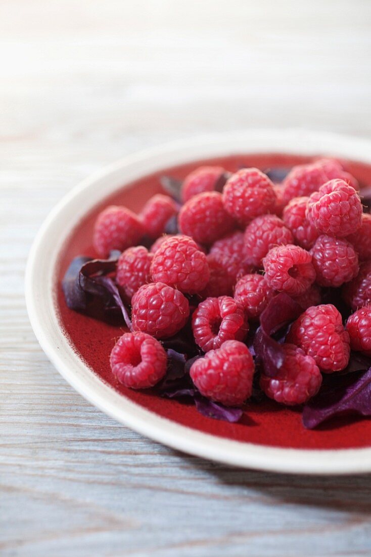 Raspberries with salad leaves