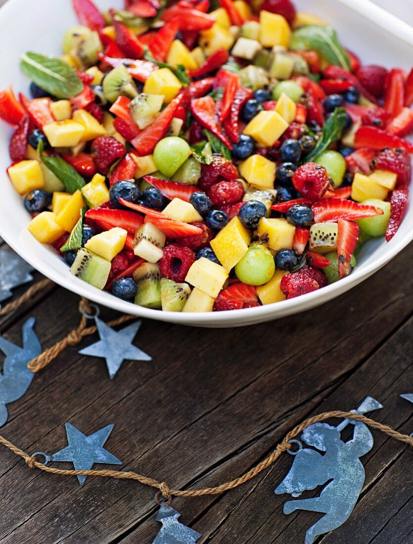 Fruit salad with passion fruit and vanilla syrup for a Christmas picnic (Australia)