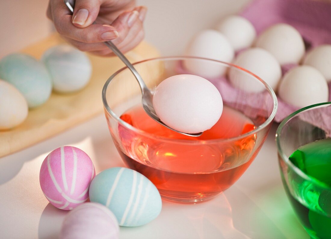 Woman colouring Easter eggs