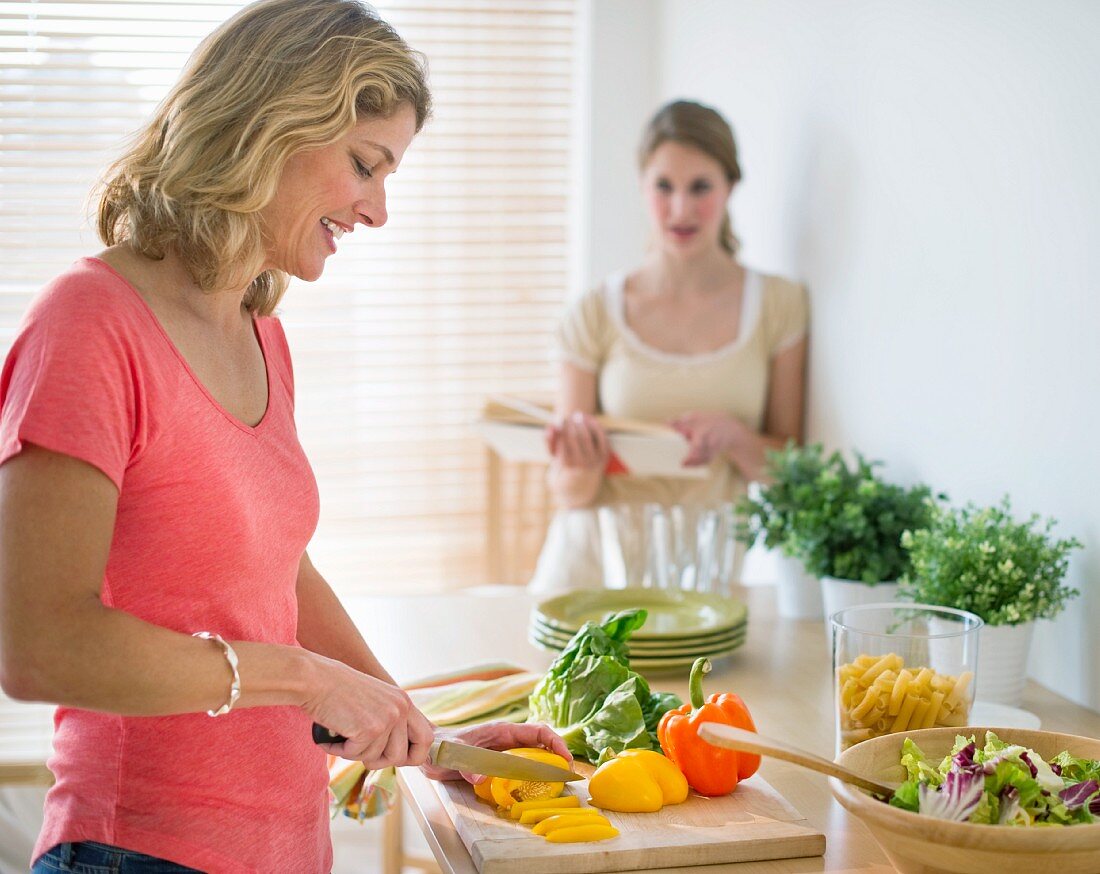 Frau bereitet Salat in der Küche zu