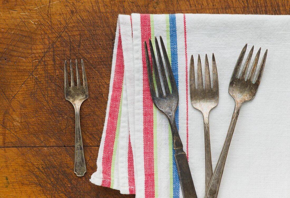 Close up of rusty silver forks and napkin