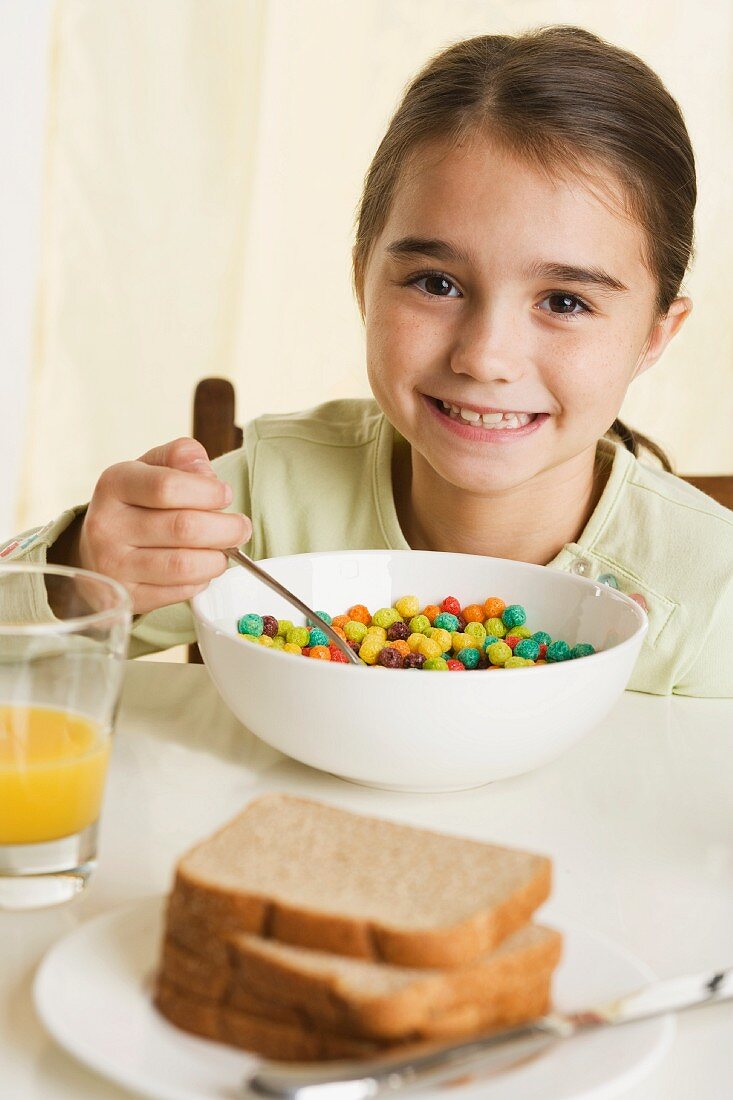 Young girl eating breakfast cereal