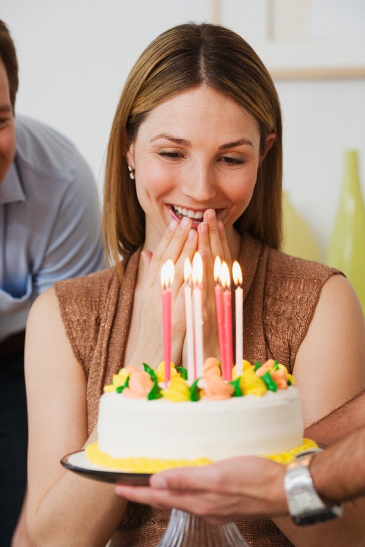 Woman smiling at birthday cake