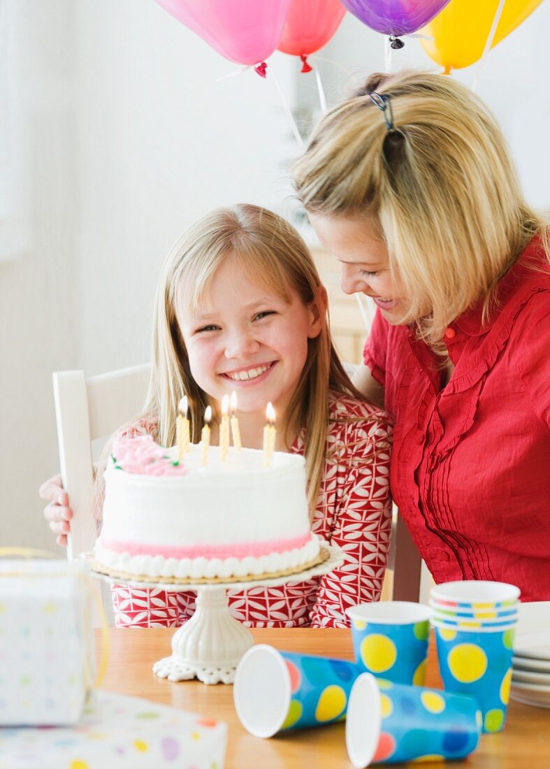 Girl celebrating birthday with mother