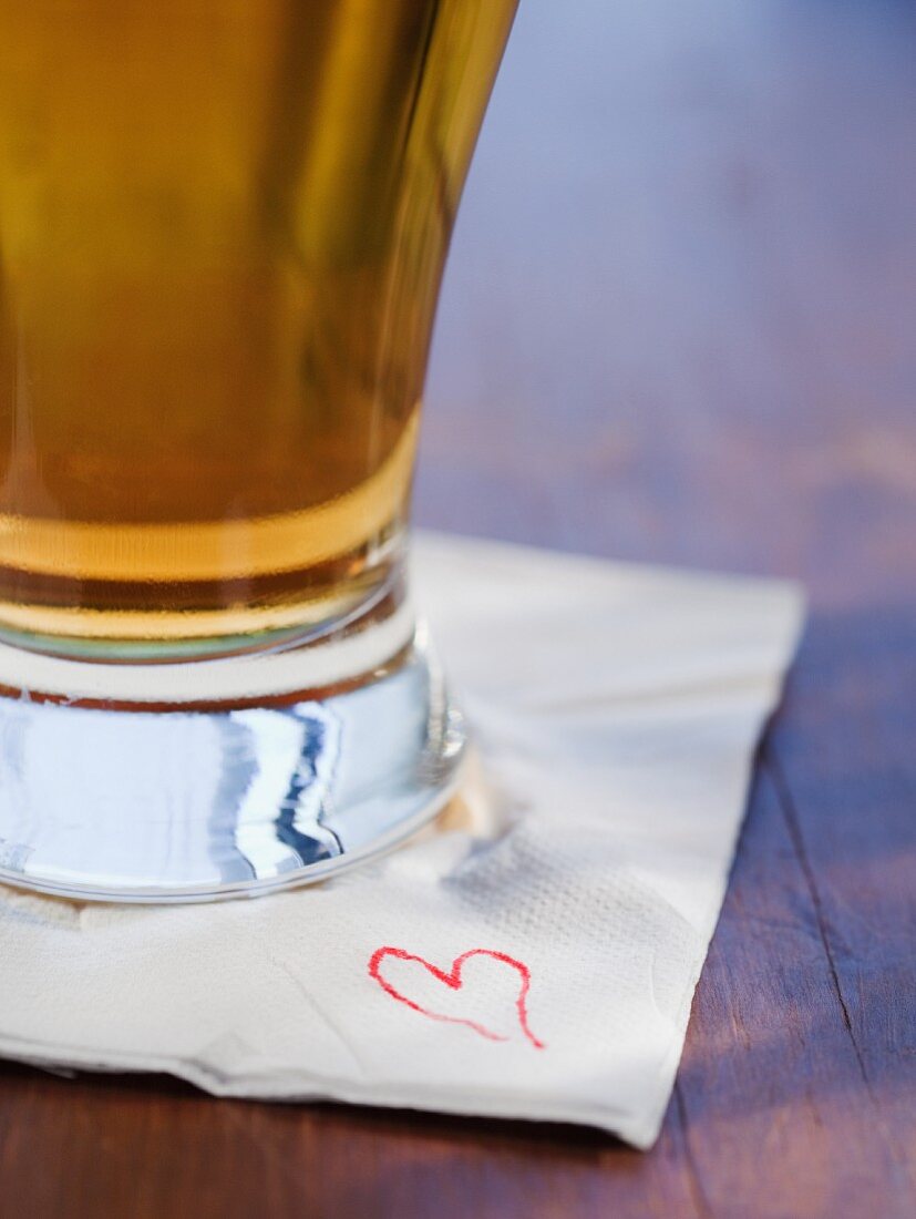 Close up of beer on heart napkin