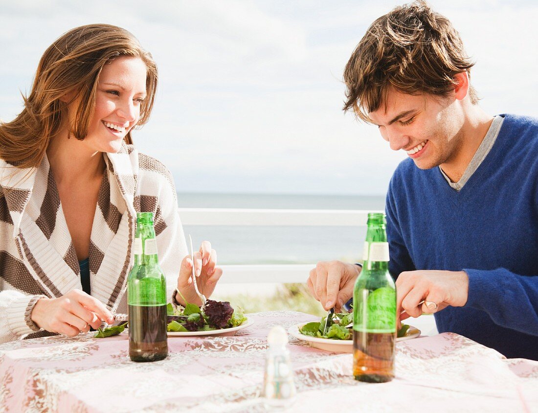 Couple eating at the beach