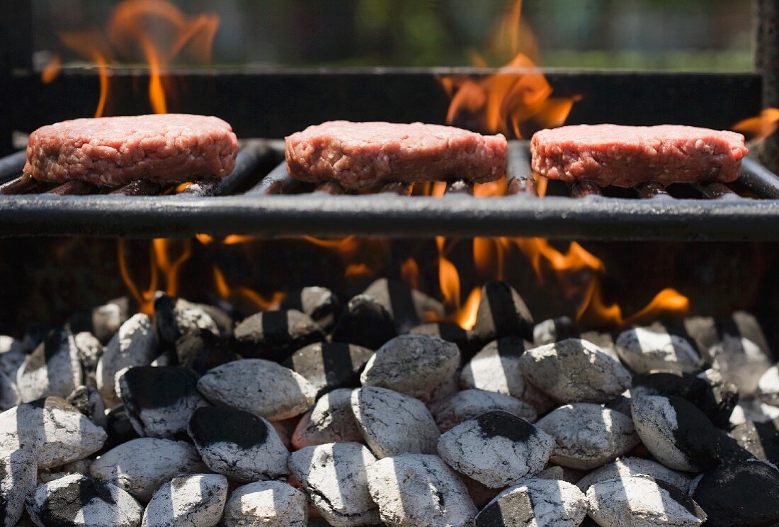 Hamburgers cooking on grill