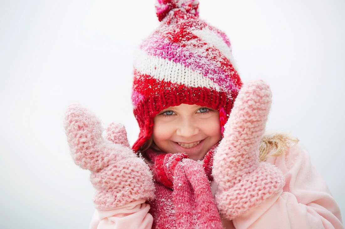 Portrait of smiling girl (8-9) wearing winter clothing