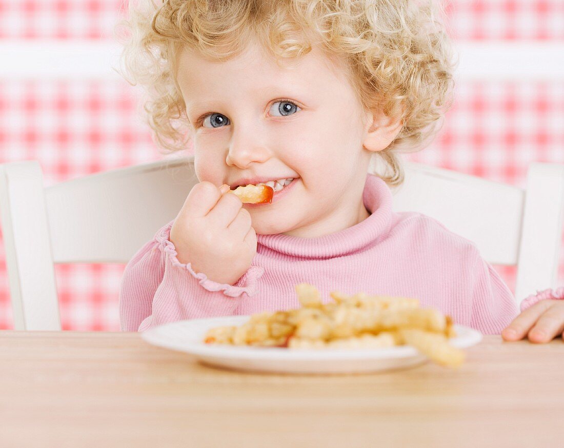 Female child eating French fries