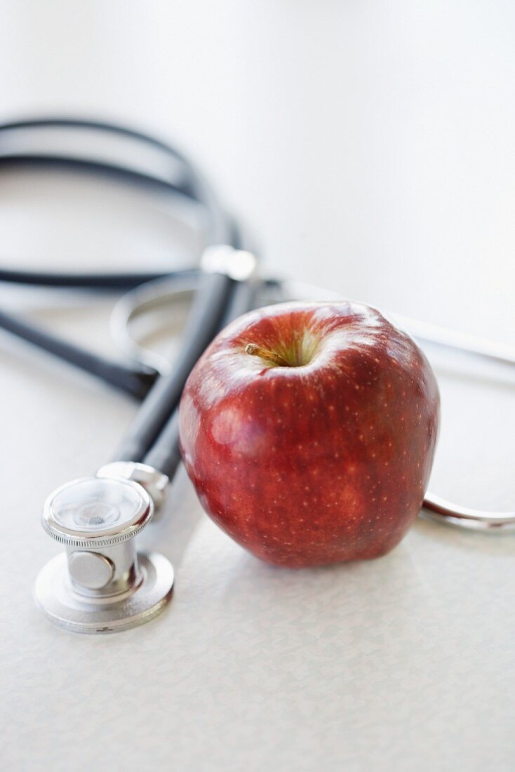 Close up of apple and stethoscope
