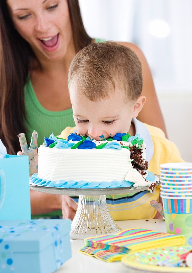 Baby eating birthday cake