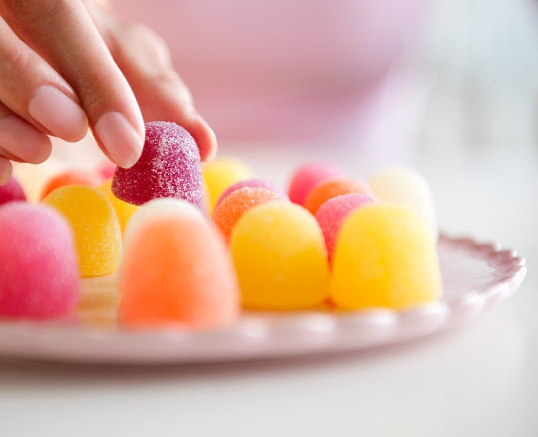 USA, New Jersey, Jersey City, Woman's hand eating jellies