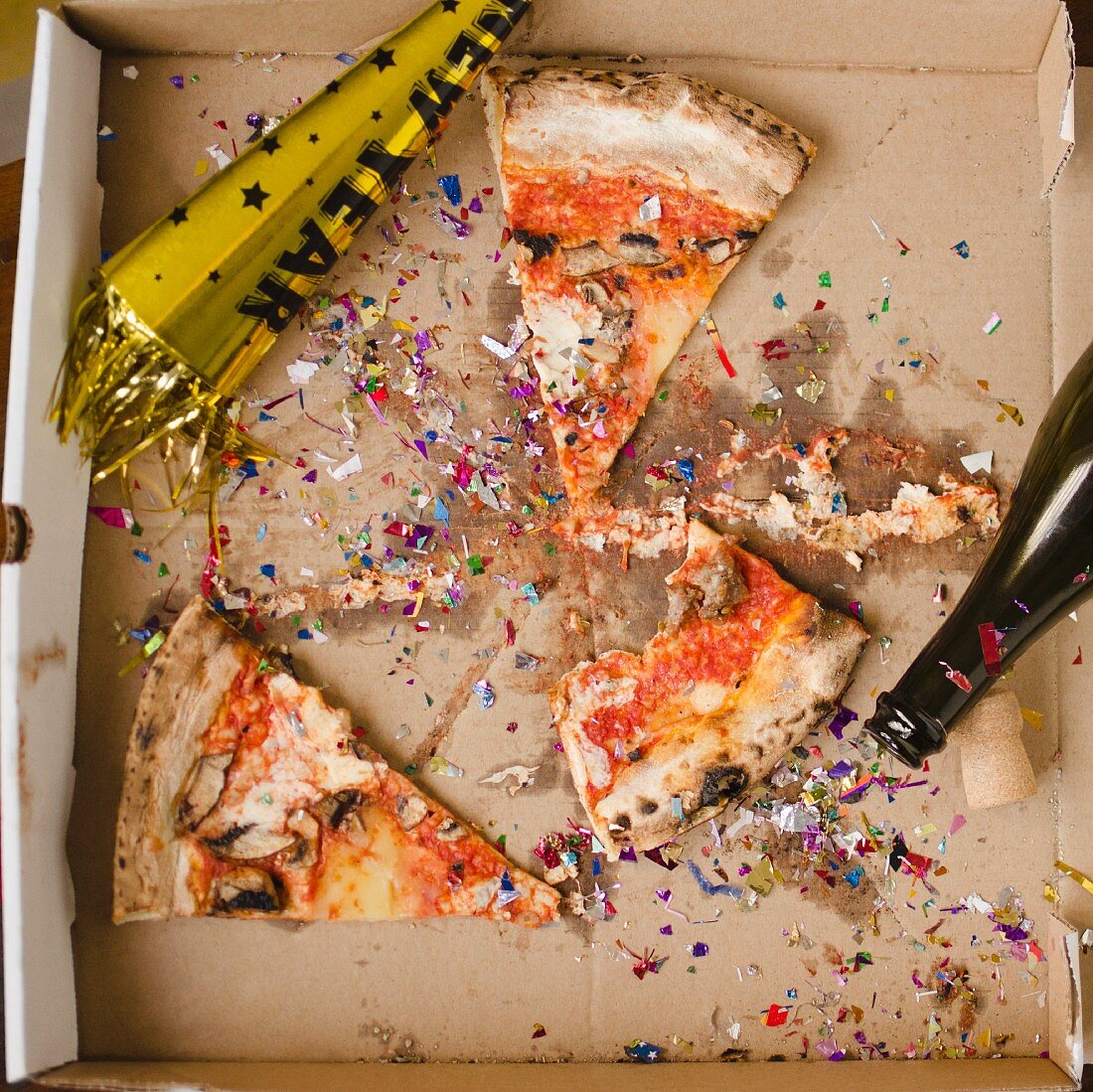 Slices of pizza and confetti in in box