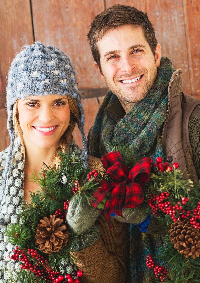 Couple holding christmas wreath