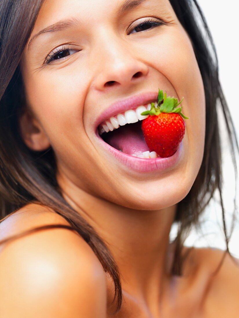 Woman eating strawberry