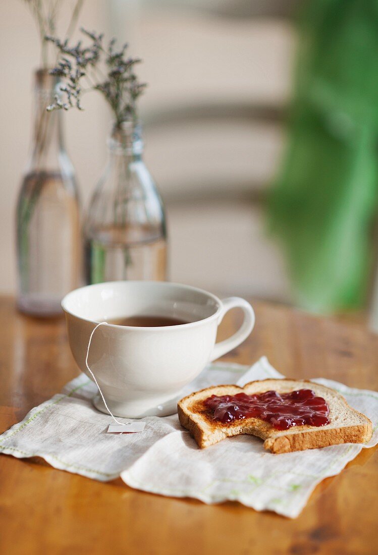 Cup of tea and toast with jam