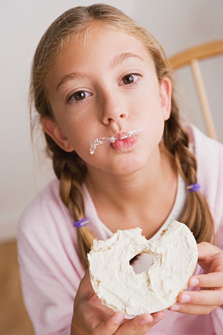 Portrait of girl (12-13) eating cake