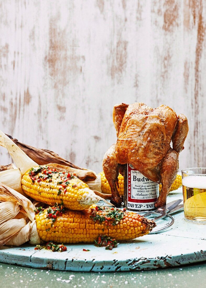 Beer can chicken and barbecued corn with chilli and parsley butter