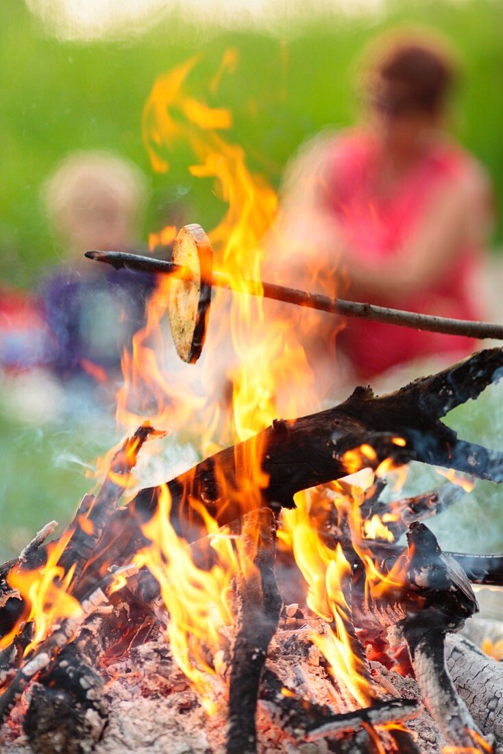 Toasting bread over the campfire