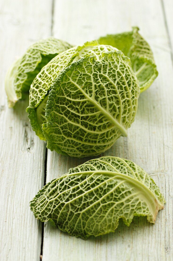 Head of savoy cabbage and leaves