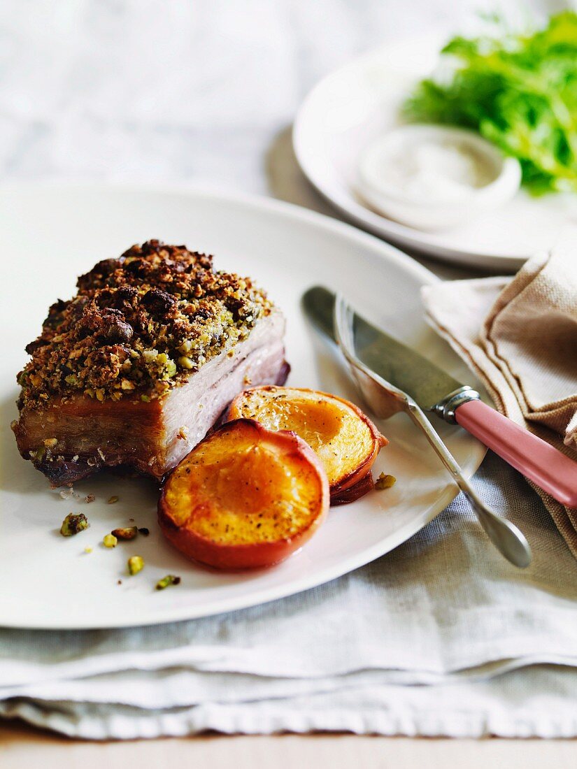 Pistachio-crusted pork with roasted peaches