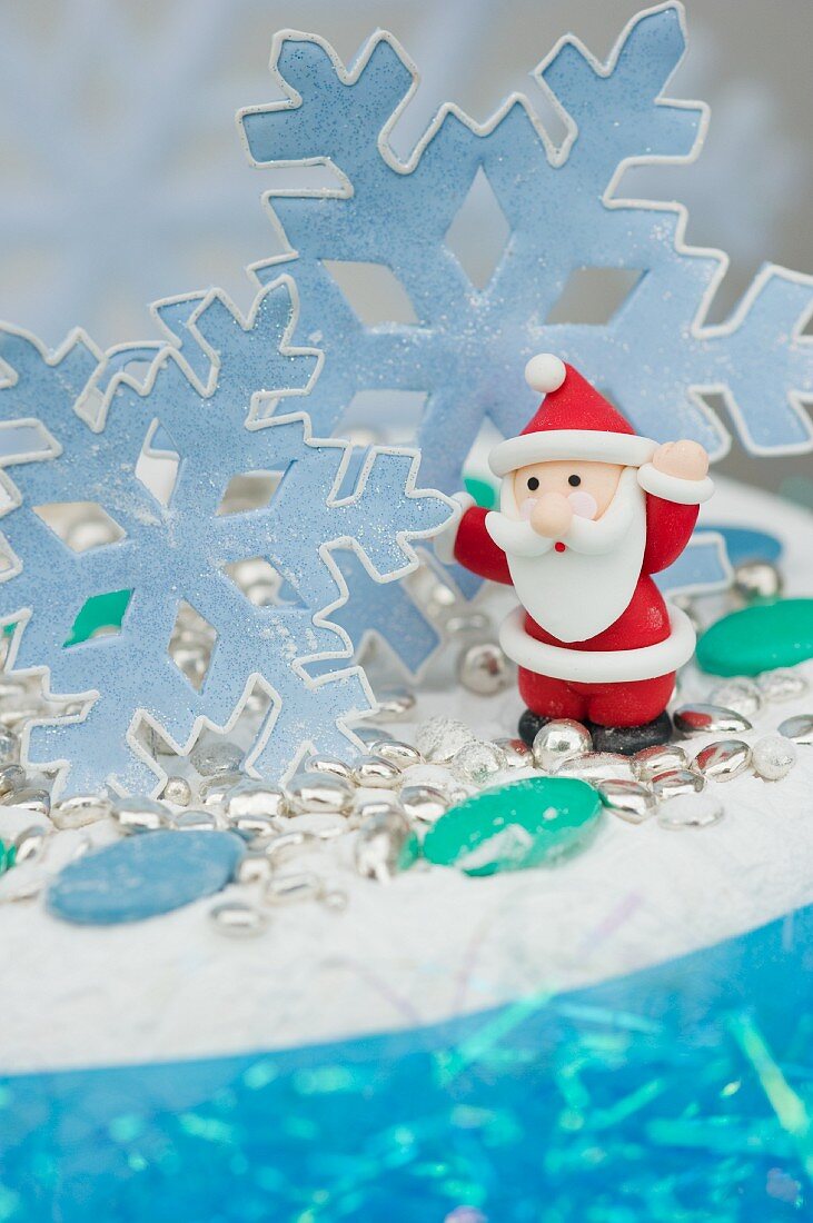 Christmas cake with snow flakes, Santa Claus and sugared almonds