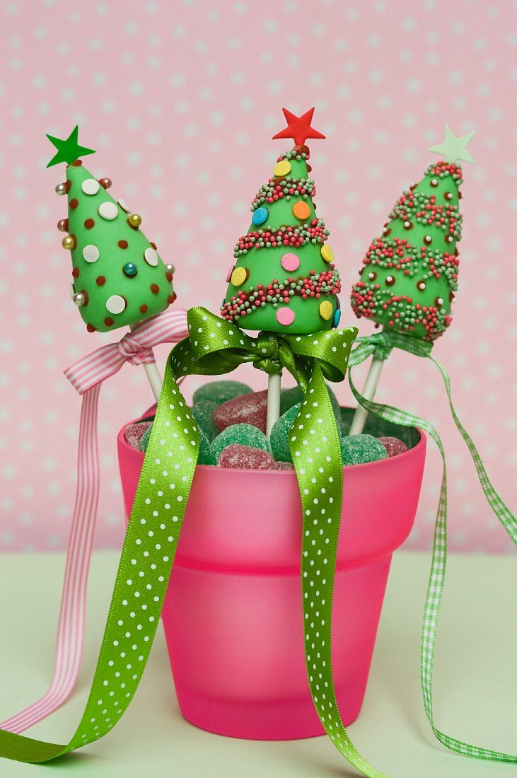 Christmas cake pops in a pot with candies