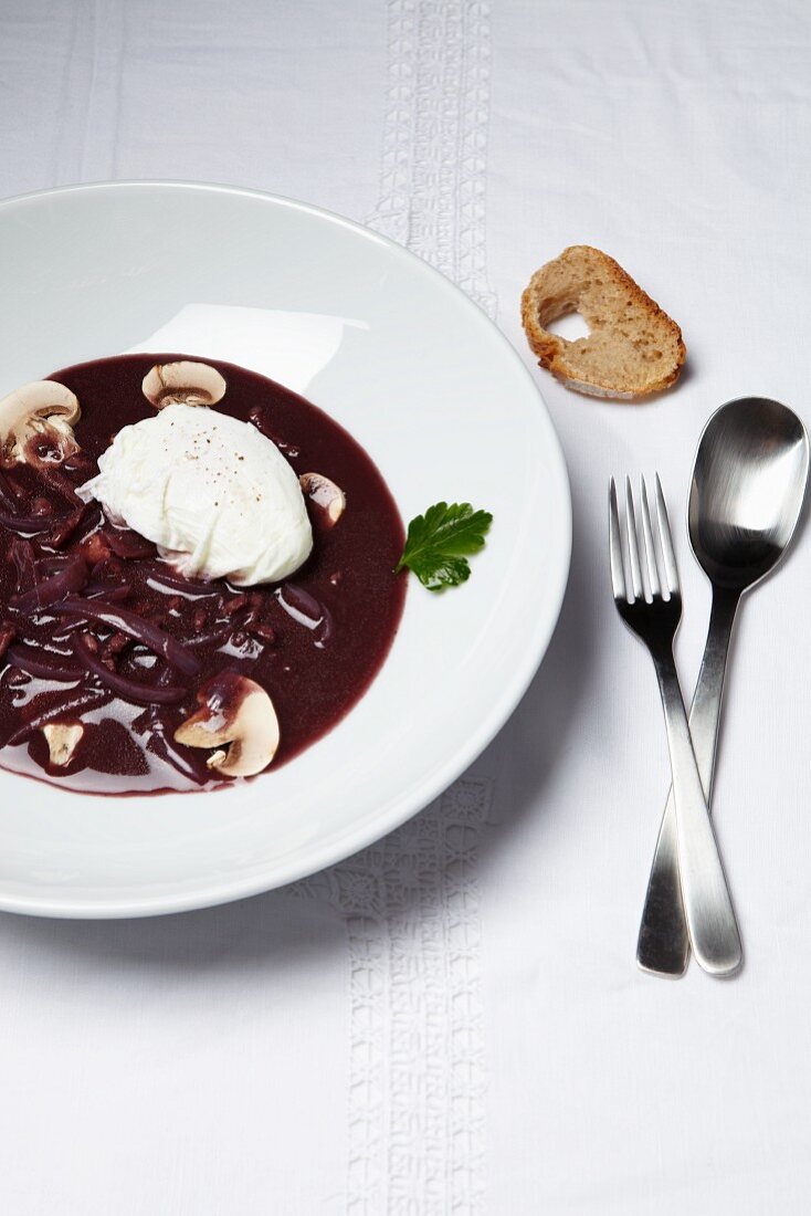Poached egg in a red wine sauce with mushrooms
