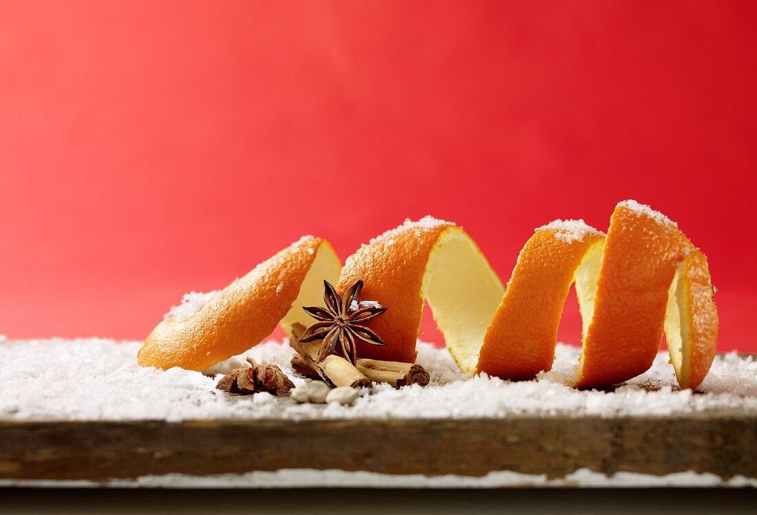 Still life with orange peel, cinnamon, star anise and powdered sugar