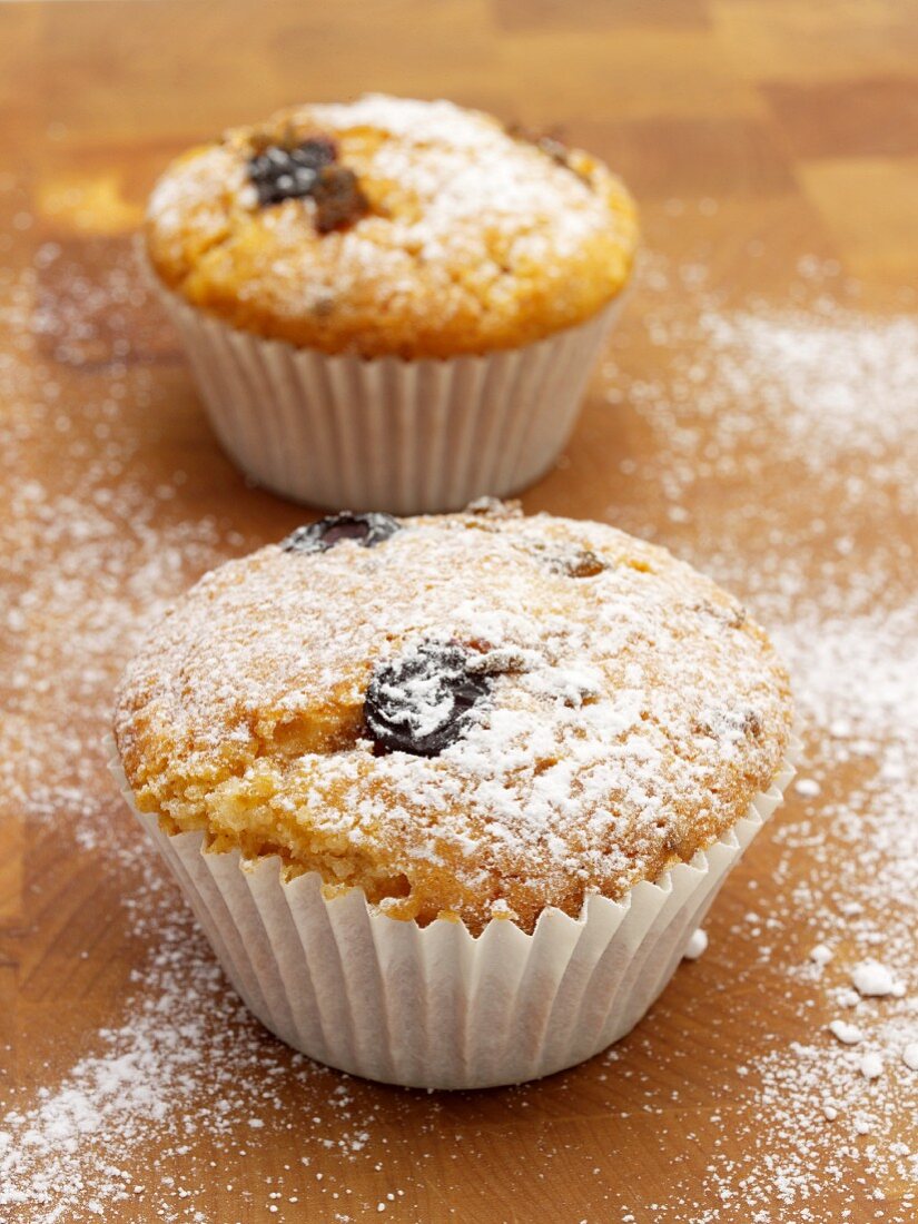 Olive muffins on a wooden surface