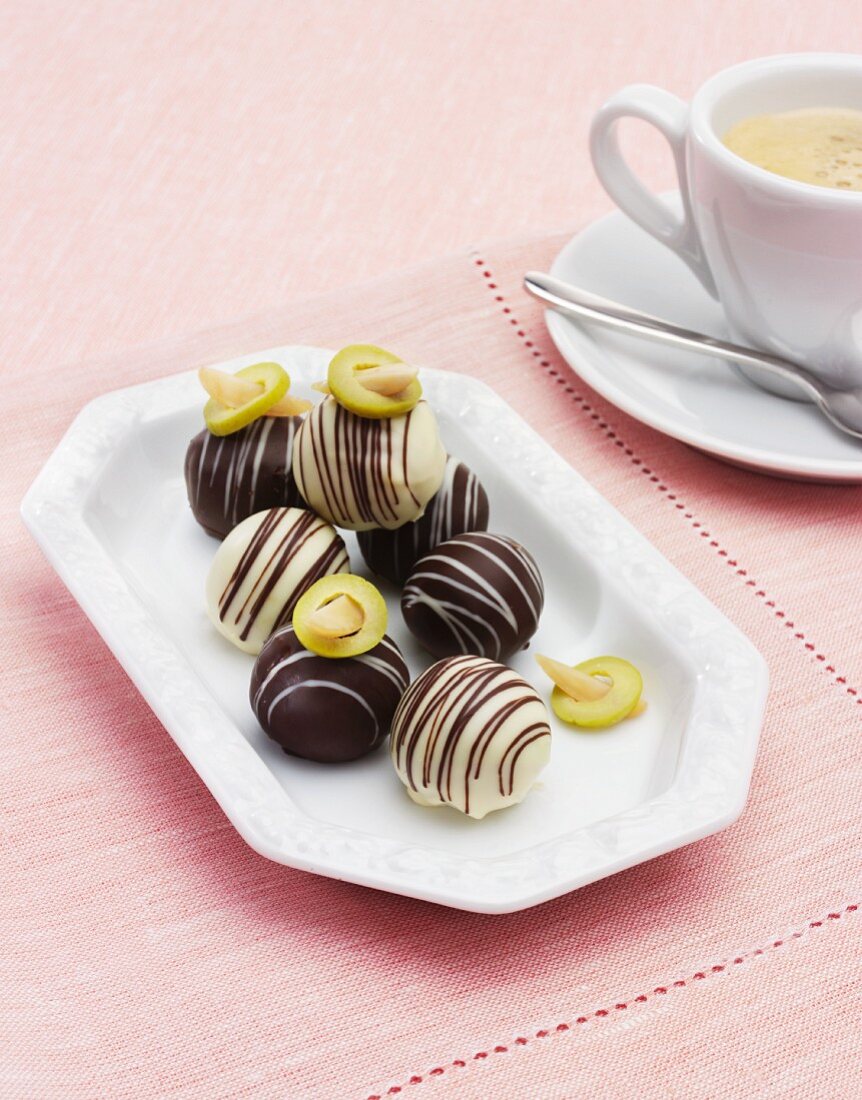 Olive pralines with a cup of coffee
