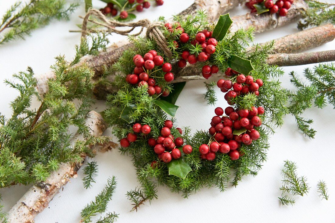 Small wreath of holly berries and conifer twigs