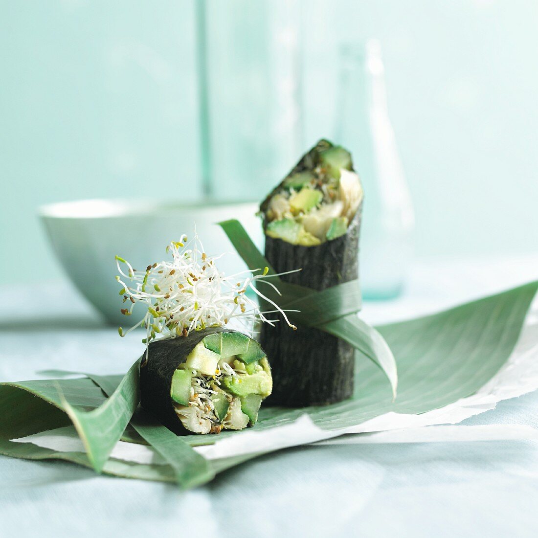 Spring rolls in nori leaves with avocado, cucumber and alfalfa sprouts