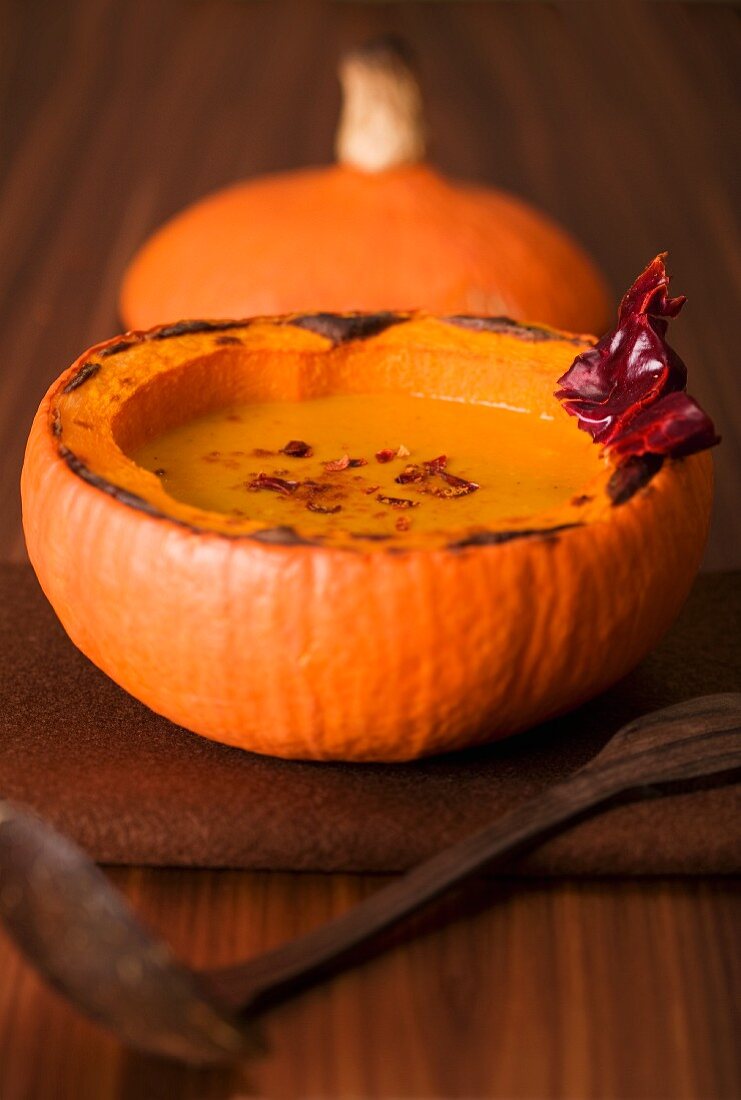 Pumpkin soup with chili in a scooped out pumpkin shell