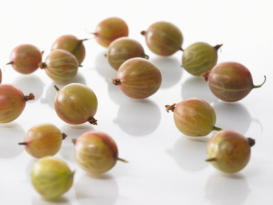 Gooseberries on a white surface