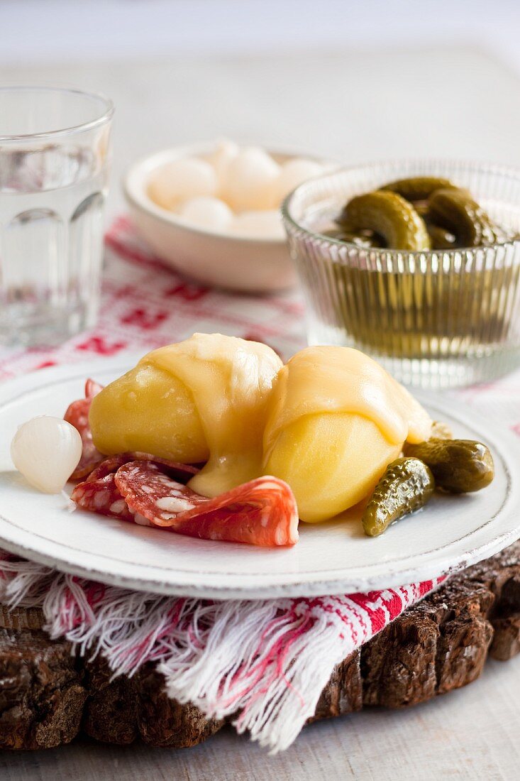 Raclette with potatoes, salami and pickles